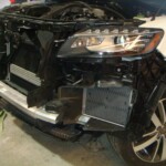 Before and after photographs of a damaged white, AUDI Quattro SUV that was repaired by Elite Paint & Body Shop in West Palm Beach, Florida.